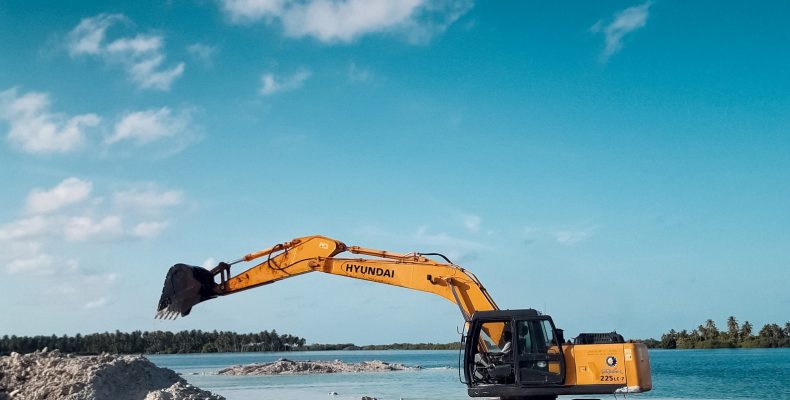 LS Aggregates excavator working near the coast